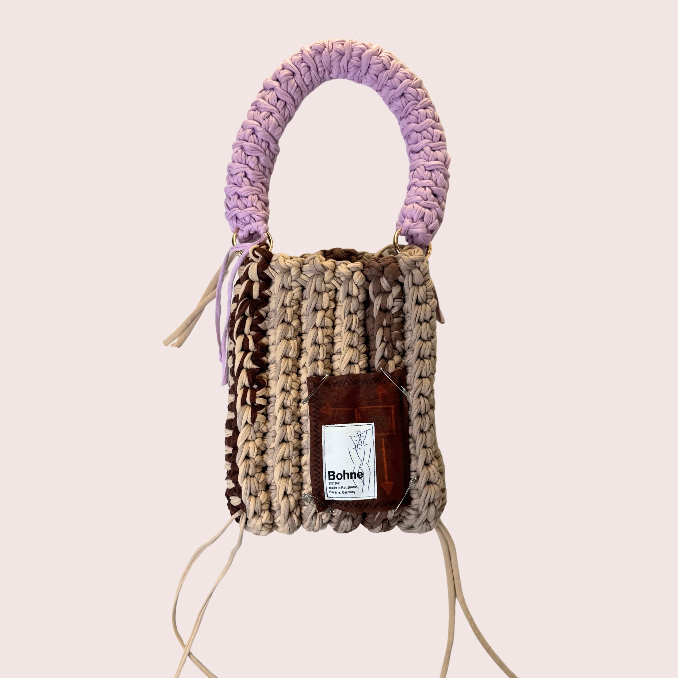 gehäkelte Schultertasche mit handbemalten Bild aus recyceltem T-Shirt Garn in beige lila freigestellt