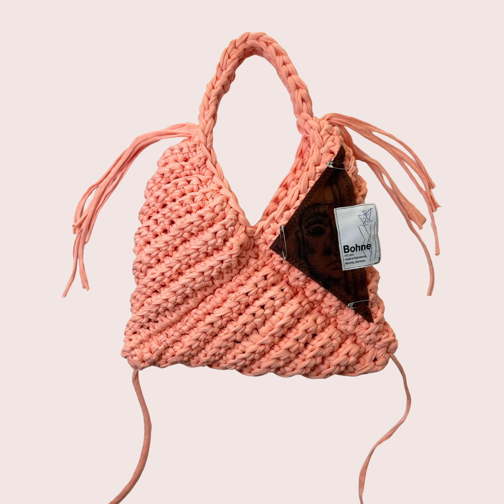 gehäkelte Schultertasche mit handbemalten Bild aus recyceltem T-Shirt Garn in lachsfarben freigestellt